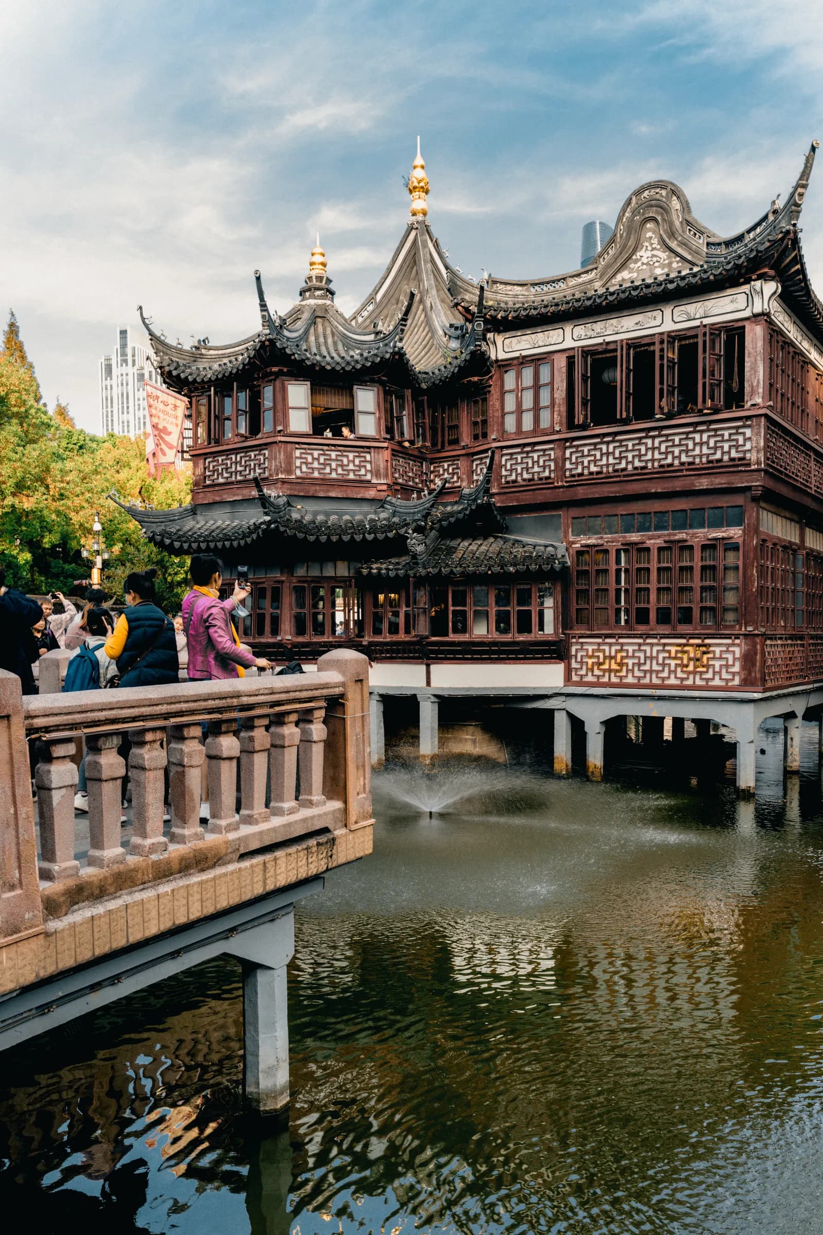 Visitors around traditional architecture and water at Yu Garden